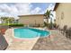 Community pool with brick patio and outdoor seating at 3221 White Ibis Ct # C1, Punta Gorda, FL 33950