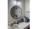 Bathroom featuring a round mirror, overhead lighting, and a white sink at 3585 41St S Way # D, St Petersburg, FL 33711