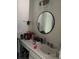 Bathroom featuring a round mirror, and a sink with storage underneath at 3585 41St S Way # D, St Petersburg, FL 33711