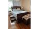 Bedroom featuring a wooden sleigh bed, hardwood floors, and two side tables with lamps at 3585 41St S Way # D, St Petersburg, FL 33711