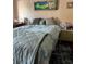 Bedroom with a mermaid painting, comfy bed with a patterned comforter, and a side table with a fan at 3585 41St S Way # D, St Petersburg, FL 33711
