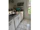 Kitchen featuring ample counter space, a stainless steel sink, and white cabinets at 3585 41St S Way # D, St Petersburg, FL 33711