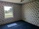 A bedroom featuring floral wallpaper, a ceiling fan, and a window at 4299 Bullard St, North Port, FL 34287