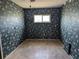 Bedroom showcasing a floral wallpaper design, window, and tile flooring at 4299 Bullard St, North Port, FL 34287