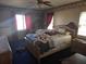 Bedroom with floral wallpaper, a large window, and a ceiling fan at 4299 Bullard St, North Port, FL 34287