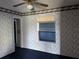Bedroom features floral wallpaper, ceiling fan and window at 4299 Bullard St, North Port, FL 34287