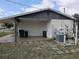 Side exterior view of house featuring covered area and pool equipment at 4299 Bullard St, North Port, FL 34287