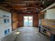 Garage view featuring wooden walls, a sliding door that exits to the outside, and work benches at 4299 Bullard St, North Port, FL 34287