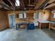 Garage featuring wooden walls, a work area, and a storage area at 4299 Bullard St, North Port, FL 34287