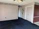 Picture of a living room displaying blue carpet, floral wallpaper, ceiling fan, and access to other rooms at 4299 Bullard St, North Port, FL 34287