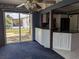 Living room that has dark blue carpet with a ceiling fan and sliding glass doors leading to the backyard at 4299 Bullard St, North Port, FL 34287