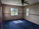 Living room with two windows and a ceiling fan at 4299 Bullard St, North Port, FL 34287