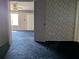 Living room featuring an open doorway and wallpapered walls at 4299 Bullard St, North Port, FL 34287