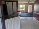 Living room view featuring dark blue carpet and a view of the front yard at 4299 Bullard St, North Port, FL 34287