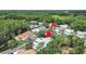 Aerial view of the neighborhood, surrounded by mature trees, is designed for peaceful living within a thriving community at 12519 Knollbrook Ln, Hudson, FL 34669
