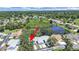 Beautiful aerial view of the property showcasing a serene pond and lush, mature landscaping at 12519 Knollbrook Ln, Hudson, FL 34669