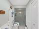 This bathroom features a shower, toilet, accessories, and a linen cabinet at 12519 Knollbrook Ln, Hudson, FL 34669