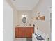 This bathroom features a sink, faucet, countertop, mirror, lighting, and drawers at 12519 Knollbrook Ln, Hudson, FL 34669