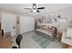 This bedroom features tile floors, ceiling fan, sofa, rug, and a large closet at 12519 Knollbrook Ln, Hudson, FL 34669