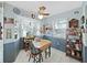 Cozy dining area with a ceiling fan, wood table, and plenty of natural light at 12519 Knollbrook Ln, Hudson, FL 34669
