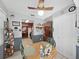 Cozy dining area with a ceiling fan, wood table, and a view to the kitchen at 12519 Knollbrook Ln, Hudson, FL 34669