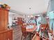 Inviting dining room with hardwood floors, chandelier, and views into the living area and kitchen at 12519 Knollbrook Ln, Hudson, FL 34669
