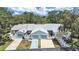 Street view of the townhomes featuring attached garages and well-maintained landscaping at 12519 Knollbrook Ln, Hudson, FL 34669