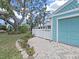 Home featuring a white fence surrounding the front yard, a paver patio, a well-kept lawn and blue exterior paint at 12519 Knollbrook Ln, Hudson, FL 34669
