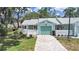 Well-kept single-story home showcases a manicured lawn, fenced yard, and a connected garage at 12519 Knollbrook Ln, Hudson, FL 34669