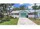 Inviting single-story home with a manicured lawn, fenced yard, and attached one-car garage at 12519 Knollbrook Ln, Hudson, FL 34669