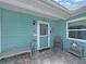 Charming front porch with brick pavers and a cozy bench, creating a welcoming entrance to this delightful home at 12519 Knollbrook Ln, Hudson, FL 34669