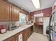 Cozy kitchen space with wooden cabinets, white countertops, and vintage decorative elements at 12519 Knollbrook Ln, Hudson, FL 34669