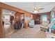 This living room has tile floors, a ceiling fan, and multiple seating areas at 12519 Knollbrook Ln, Hudson, FL 34669