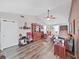 Inviting living room with wood flooring, a ceiling fan, and lots of natural light at 12519 Knollbrook Ln, Hudson, FL 34669
