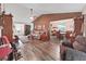 The open living room flows into a dining area with wood flooring and natural light at 12519 Knollbrook Ln, Hudson, FL 34669