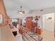 Inviting living room with wood flooring, a ceiling fan, and lots of natural light at 12519 Knollbrook Ln, Hudson, FL 34669