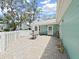 Paver patio offers a comfortable outdoor space, ideal for enjoying fresh air and natural sunlight, with a shady oak tree nearby at 12519 Knollbrook Ln, Hudson, FL 34669