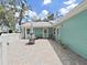 Enjoy outdoor living on the spacious paved patio, perfect for entertaining and relaxing underneath a large shade tree at 12519 Knollbrook Ln, Hudson, FL 34669