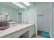 Bright bathroom with long vanity and view into a second full bathroom at 6108 Penny Ln # 0, Bradenton, FL 34207