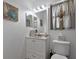 Charming half bathroom with white vanity, decorative mirror, and coastal decor at 6108 Penny Ln # 0, Bradenton, FL 34207
