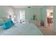 Bedroom featuring a comfortable bed, wicker dresser, and adjoining spaces at 6108 Penny Ln # 0, Bradenton, FL 34207