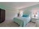Bedroom with large bed, turquoise accents, and light-filtering blinds at 6108 Penny Ln # 0, Bradenton, FL 34207