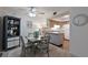 Open dining area with stylish table, chairs, and bar cabinet next to a bright kitchen at 6108 Penny Ln # 0, Bradenton, FL 34207