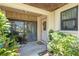 Inviting covered front porch with plants and view inside through glass doors at 6108 Penny Ln # 0, Bradenton, FL 34207