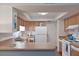 Cozy kitchen with bright cabinets, white appliances, and a breakfast bar at 6108 Penny Ln # 0, Bradenton, FL 34207