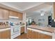 Inviting kitchen area with wood cabinets, stove, and microwave at 6108 Penny Ln # 0, Bradenton, FL 34207