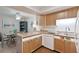 Bright kitchen featuring light wood cabinets, and an island with seating at 6108 Penny Ln # 0, Bradenton, FL 34207