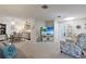 Spacious living room with open floor plan, cozy seating, and access to dining area and kitchen at 6108 Penny Ln # 0, Bradenton, FL 34207