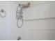 Bathroom with white tile walls and a shower head with shelves for storage at 2616 Bayshore Gardens Pkwy, Bradenton, FL 34207