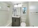 Bright bathroom featuring a shower, vanity, and a window at 2616 Bayshore Gardens Pkwy, Bradenton, FL 34207